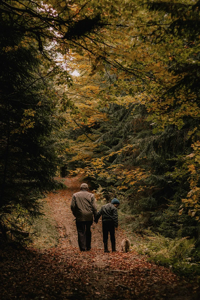 Grandfather walking with grandson sharing memoiries
